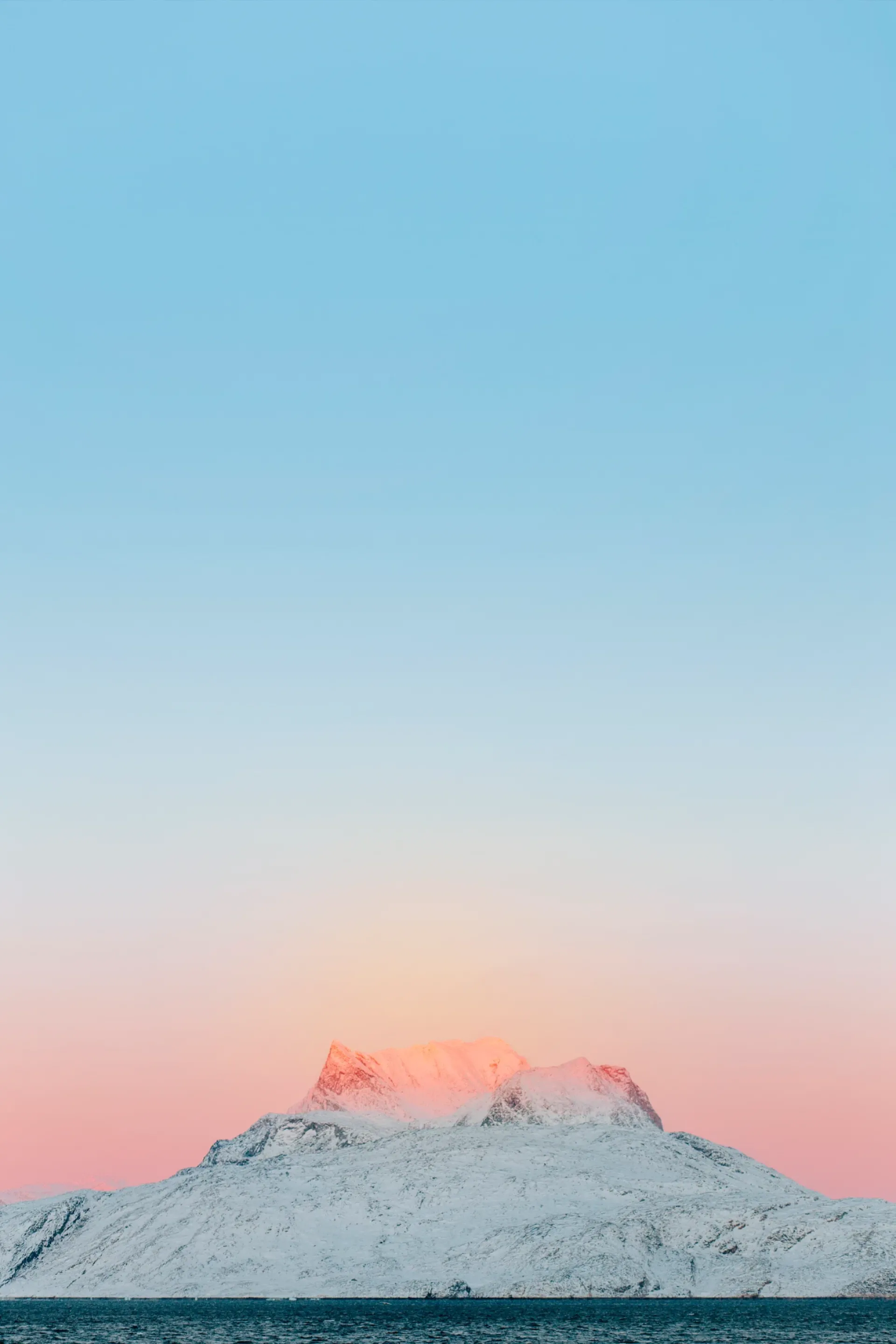 Sunset on a snowy mountain peak — Alaska's communities